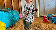 Sawyer joined the competition — help win amazing prizes! child, toddler, smiling, laughing, standing, portrait, indoors, playroom, construction, wooden_floor, bed, blanket, toy, toy_vehicle, football_pattern, ball, play_mat, sneakers, daylight, happy