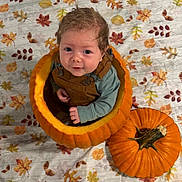Bryson is registered to the contest to win money with this photo: baby, pumpkin, autumn, fall, leaf_pattern, blanket, orange, child, cute, overalls, smiling, sitting, head, face, seasonal, holiday, indoors, portrait, costume, festive
