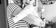 Louna a rejoint le concours — aidez-le/la à gagner de superbes lots ! baby, person, smile, striped_shirt, holding, indoor, black_and_white, tattoo, jeans, happy, face, arm, home, portrait, child, furniture, shelf, doorway, floor, cozy