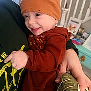 Björn joined the competition — help win amazing prizes! baby, child, smiling, orange_hat, orange_clothing, hand, person, indoor, home, stairs, furniture, toy_shoes, cute, happy, holding, portrait, cozy, warm_colors, infant, toddler