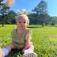 Lila joined the competition — help win amazing prizes! baby, child, grass, outdoor, blue_sky, greenery, pigtails, bow, cute, sitting, sunlight, nature, portrait, solemn, footwear, white_socks, summer, daytime, person, young_child
