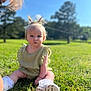 baby, child, grass, outdoor, blue_sky, greenery, pigtails, bow, cute, sitting, sunlight, nature, portrait, solemn, footwear, white_socks, summer, daytime, person, young_child