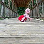 Lila joined the competition — help win amazing prizes! toddler, child, red_dress, smiling, crawling, wooden_bridge, outdoor, nature, greenery, covered_bridge, wooden_floor, happy, playful, person, young_child, daylight, summer, portrait, cute, blonde_hair
