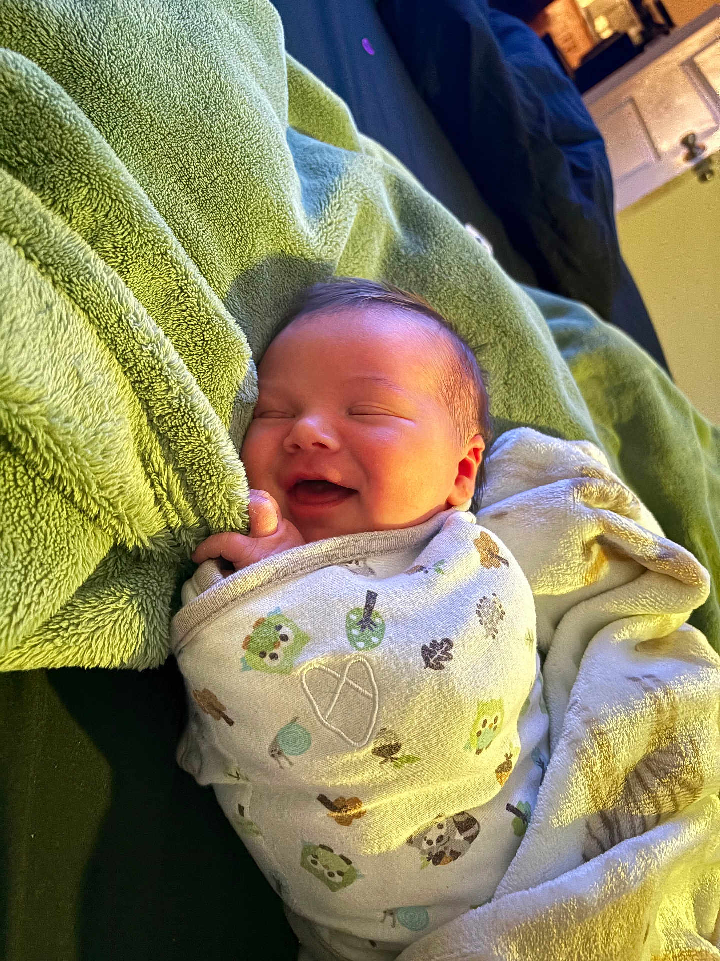 Aiden James is registered to the contest to win money with this photo: baby, swaddle, blanket, smile, sleeping, towel, infant, cozy, cute, bedroom, soft, pattern, animal_print, indoors, newborn, wrapped, happy, rest, warm, comfort