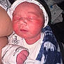Aiden James joined the competition — help win amazing prizes! newborn, baby, sleeping, blanket, blue, white, cap, onesie, dinosaur_pattern, infant, closeup, face, hand, cozy, cute, indoor, child, person, soft, resting