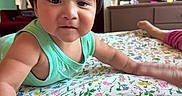 Gael Alexander is registered to the contest to win money with this photo: baby, child, toddler, crawling, face, portrait, indoors, bedroom, bed, floral, blanket, green_clothing, dark_hair, fringe, eyes, curious, infant, home, dresser, photography