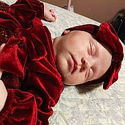 Mivah is registered to the contest to win money with this photo: baby, sleeping, red_velvet, headband, infant, bedspread, soft, peaceful, child, portrait, closeup, cute, hand, clothing, indoors, resting, face, newborn, toddler, cozy