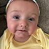 Peyton joined the competition — help win amazing prizes! baby, infant, face, headband, yellow_clothing, close_up, portrait, cute, skin, cheeks, eyes, eyelashes, headwear, apparel, lying_down, texture, fabric, soft_lighting, expression, person