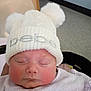 Peyton joined the competition — help win amazing prizes! baby, sleeping, hat, pom_poms, white_hat, rosy_cheeks, infant, cute, cozy, soft_clothing, indoor, portrait, child, newborn, headwear, face, closed_eyes, pink_cheeks, warm, candid