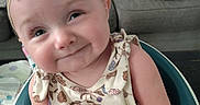 Peyton joined the competition — help win amazing prizes! arm, baby, bow, chair, child, couch, cute, face, floral_outfit, happy, head, headband, indoor, infant, person, pillow, portrait, sitting, skin, smiling