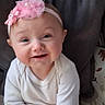 apparel, baby, cheerful, child, cozy, cushion, cute, expression, face, headband, human, indoors, infant, pink, portrait, sitting, skin, smile, white_clothing, young_child