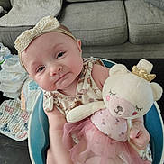 Peyton is registered to the contest to win money with this photo: baby, infant, headband, plush_toy, teddy_bear, pink_tutu, golden_crown, baby_seat, couch, diapers, blanket, living_room, cute, child, soft_toy, happy, indoors, portrait, smiling, clothing
