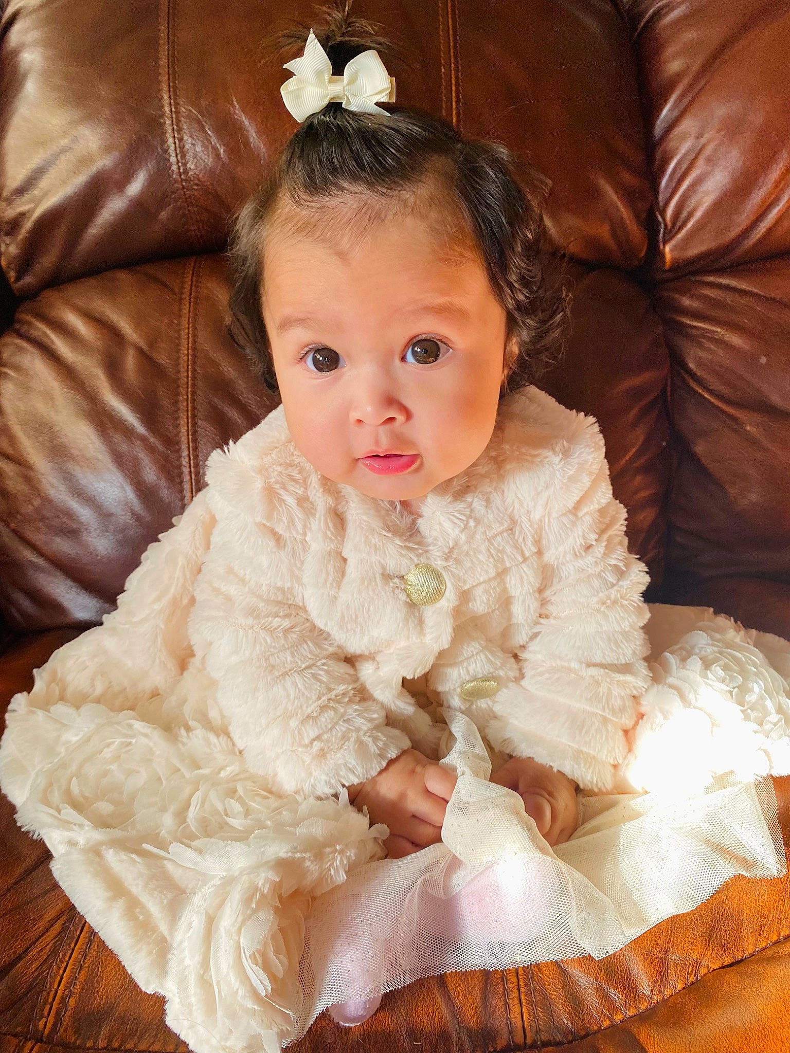 Alaina is registered to the contest to win money with this photo: baby, baby_toddler_clothing, bridal_accessory, child, comfort, couch, dress, embellishment, flash_photography, flooring, formal_wear, happy, headpiece, jewellery, person, sitting, sleeve, smile, textile, toddler
