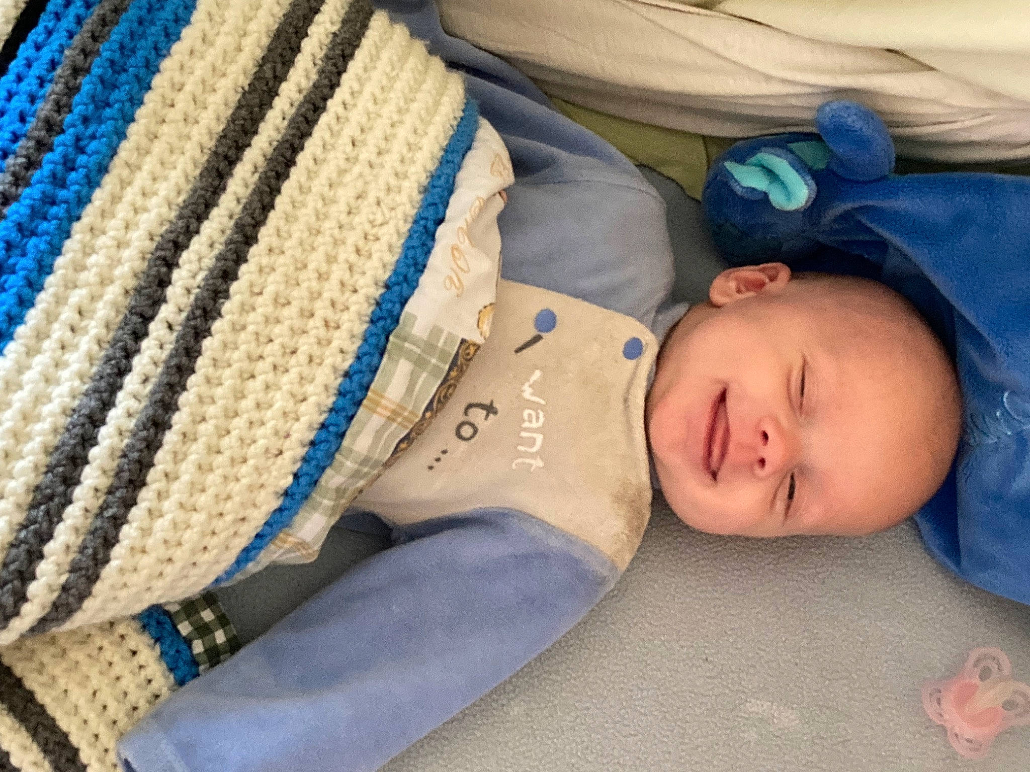 Owen participe au concours pour gagner de l'argent avec cette photo : baby, baby_products, baby_sleeping, baby_toddler_clothing, bedtime, child, comfort, electric_blue, fashion_accessory, headgear, linens, nap, pattern, person, sitting, skin, sleeve, textile, toddler, wood