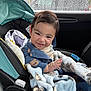 baby, child, car_seat, blanket, smiling, indoors, rain, window, car, seatbelt, cute, portrait, happy, clothing, baby_clothes, infant, people, face, expression, child_seat