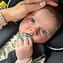 baby, blue_eyes, pacifier, hand, car_seat, clothing, face, infant, cute, child, close_up, person, sitting, holding, skin, head, nail_polish, comfort, car, seatbelt