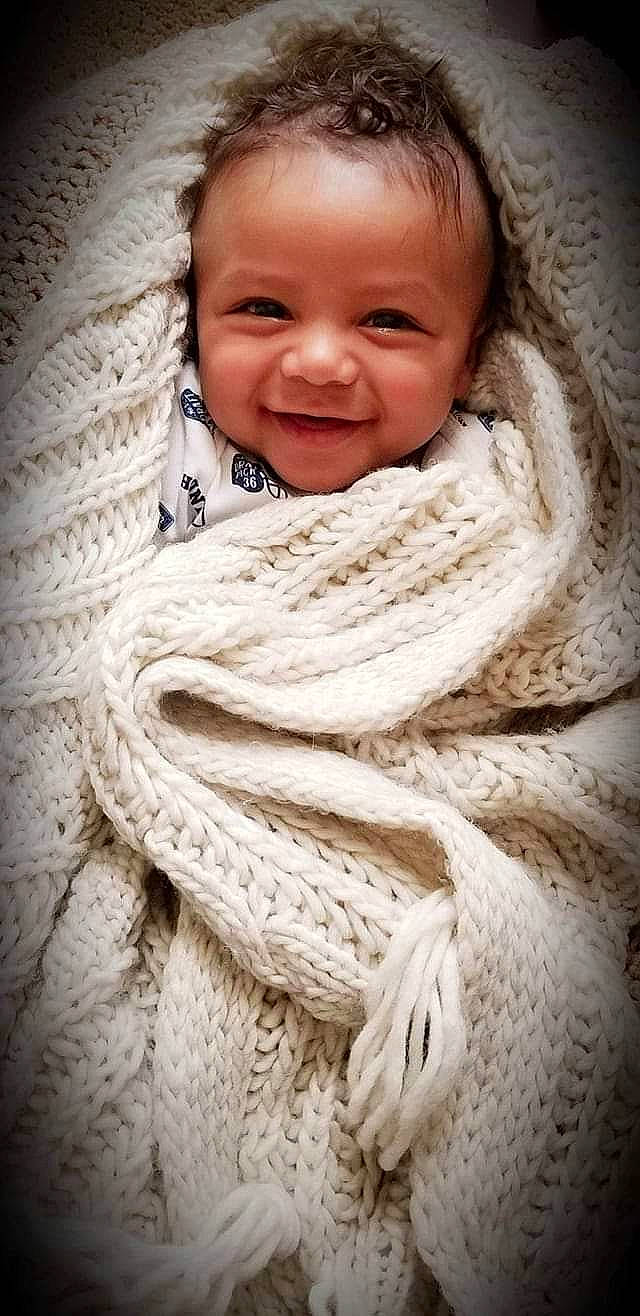 Iverson is registered to the contest to win money with this photo: child, close_up, eye, girl, infant, joy, knitting, nose, person, portrait_photography, smile, textile, wool