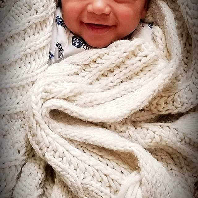 Iverson is registered to the contest to win money with this photo: child, close_up, eye, girl, infant, joy, knitting, nose, person, portrait_photography, smile, textile, wool