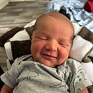 Kody is registered to the contest to win money with this photo: baby, newborn, smile, sleeping, blanket, onesie, dinosaur, infant, cute, indoors, child, peaceful, portrait, soft, clothing, face, happy, resting, head, cozy