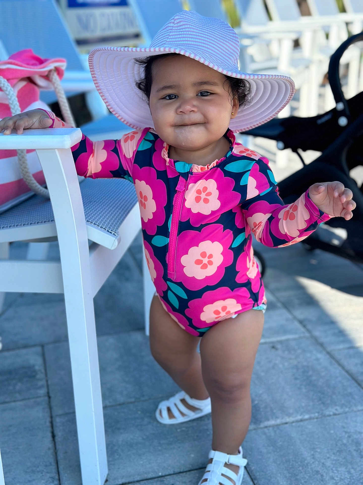 Gabriella joined the competition — help win amazing prizes! baby, cap, chair, clothing, dress, face, footwear, furniture, hat, head, outdoors, person, photography, portrait, sandal, shoe, shorts, sitting, summer, sunhat