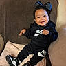 Delilah joined the competition — help win amazing prizes! baby, child, smiling, sitting, nike, sneakers, black_clothing, bow, blanket, couch, indoors, happy, cute, face, footwear, person, apparel, cozy, infant, portrait