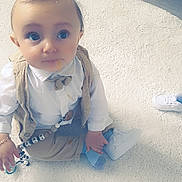 Eden participe au concours pour gagner de l'argent avec cette photo : baby, child, indoor, white_rug, pacifier, beads, clothing, shoe, sock, floor, toy, heart_emoji, cute, portrait, sitting, expression, infant, wood_floor, casual, accessory