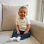 Noé participe au concours pour gagner de l'argent avec cette photo : blue_jeans, casual_clothing, child, couch, cozy, cute, face, happy, home, indoors, light, pillow, portrait, sitting, smiling, socks, toddler, white_shirt, window, young_child
