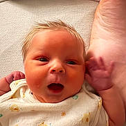 Kenneth joined the competition — help win amazing prizes! apparel, baby, child, closeup, cute, expression, face, family, foot, hand, human, indoors, infant, lying_down, newborn, playful, skin, soft, texture, white_clothing