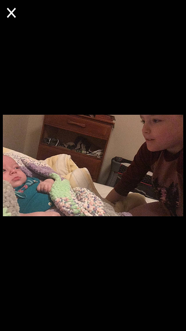 Braiden is registered to the contest to win money with this photo: baby, bed, child, cloud, comfort, darkness, elbow, electronic_device, event, finger, flash_photography, fun, gesture, headwear, linens, mouth, person, pillow, sitting, sleeve