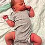newborn, baby, infant, sleeping, onesie, hospital_band, ankle_band, bed, blanket, skin, arm, leg, diaper, foot, peaceful, resting, indoors, person, cute, healthcare