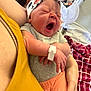 baby, yawning, headband, infant, person, arm, clothing, blanket, fan, red, orange, gray, hand, holding, indoor, cute, sleepy, fabric, newborn, skin