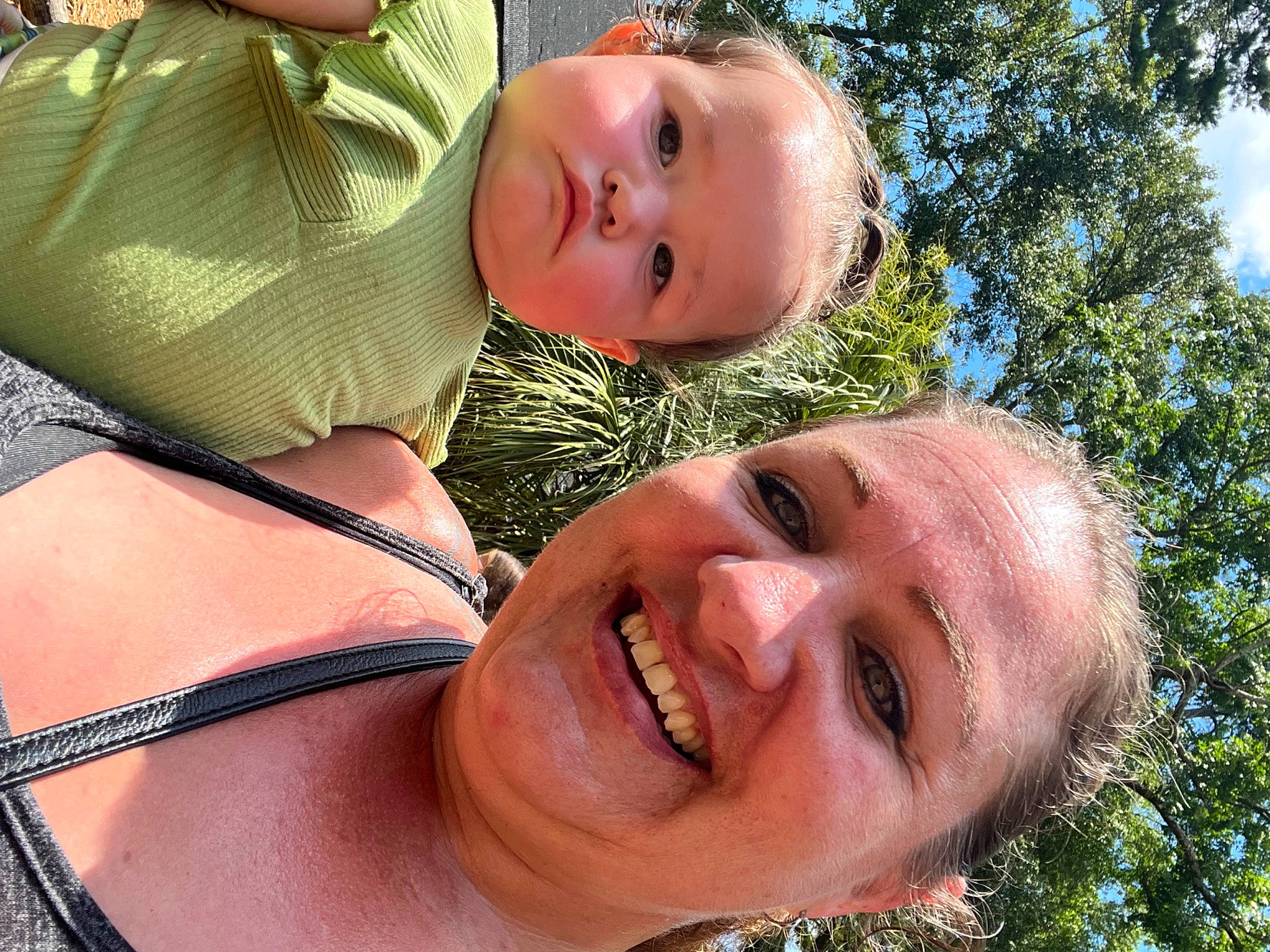 Mira is registered to the contest to win money with this photo: abdomen, cheek, chest, child, event, fun, gesture, grass, green, happy, joy, leisure, mouth, nose, people_in_nature, person, skin, sky, smile, toddler