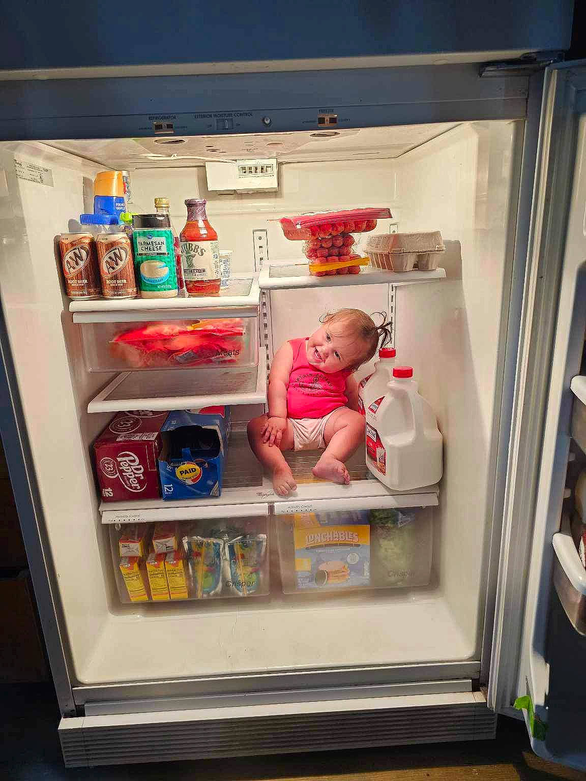 Mira is registered to the contest to win money with this photo: baby, bottle, carbonated_soft_drinks, display_case, food_storage, freezer, home_appliance, joy, kitchen_appliance, machine, major_appliance, pantry, person, plastic, plastic_bottle, product, refrigerator, room, shelf, shelving