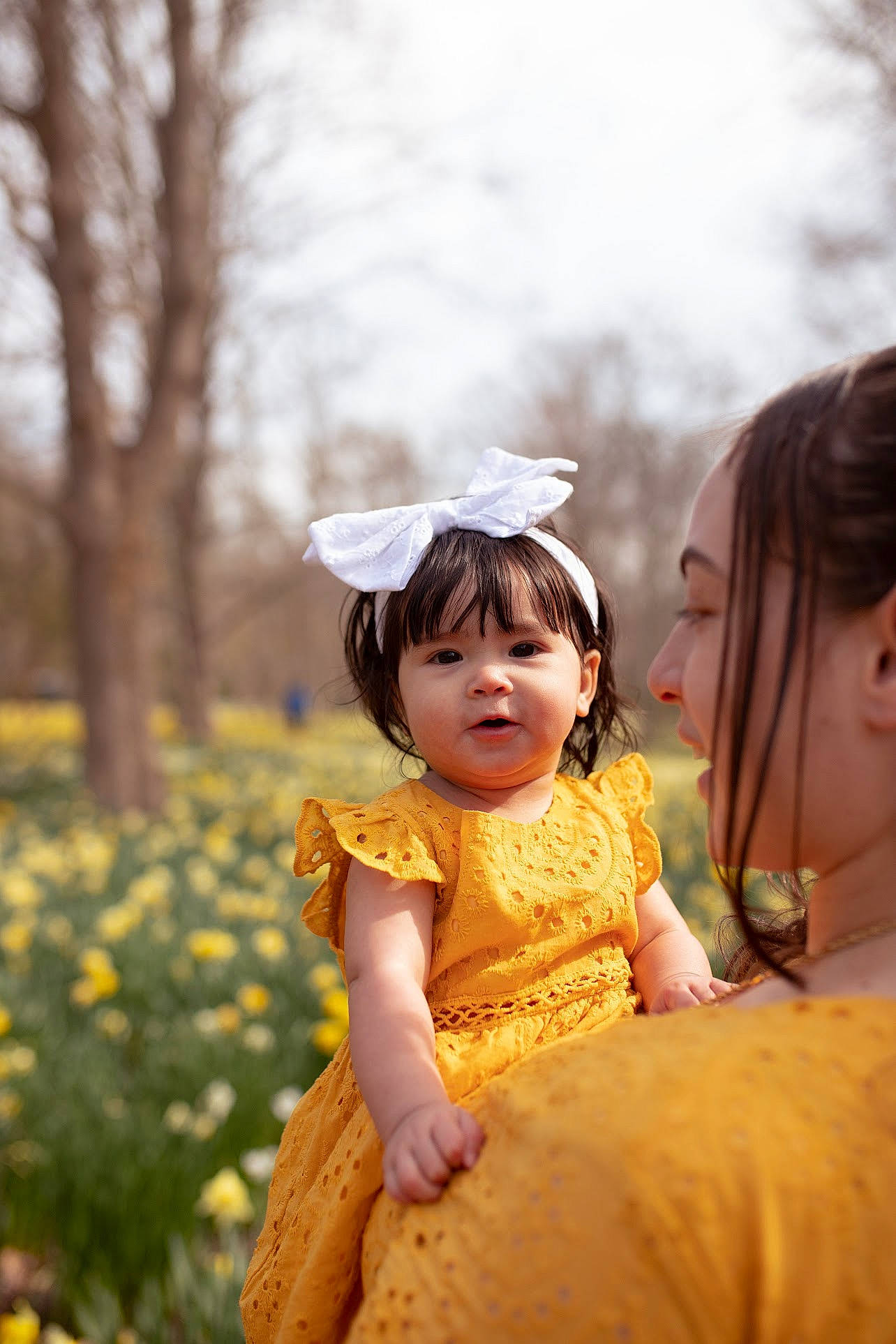 Aliana is registered to the contest to win money with this photo: baby, child, dress, event, face, flower, fun, grass, happy, jewellery, peach, people_in_nature, person, plant, portrait_photography, recreation, skin, sky, toddler, tradition