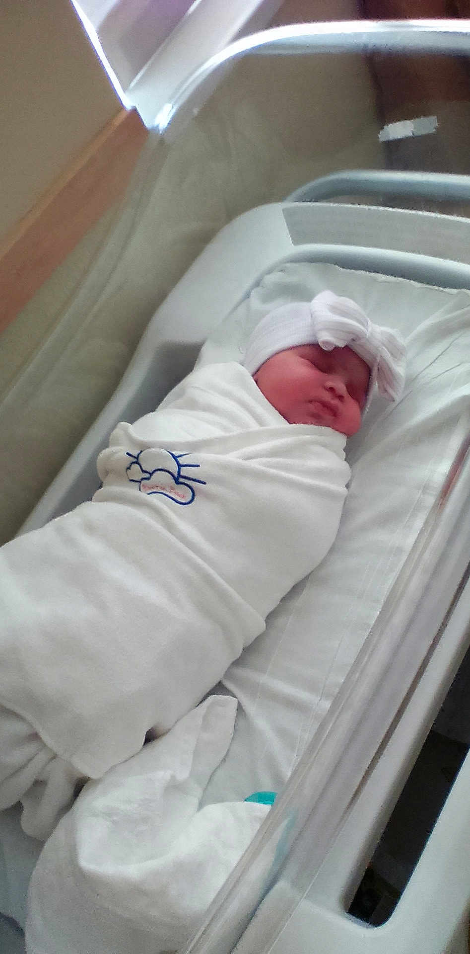 Skylar is registered to the contest to win money with this photo: newborn, baby, hospital, blanket, bassinet, bed, swaddled, hat, sleeping, infant, cute, white, resting, healthcare, child, person, indoors, soft, peaceful, portrait