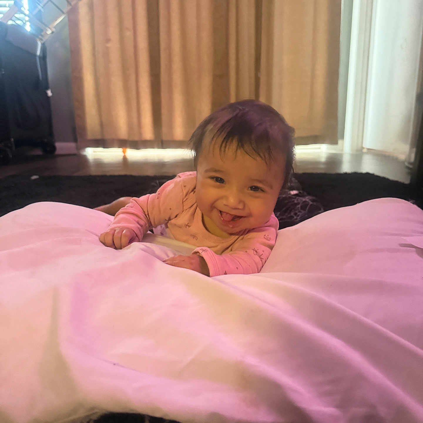 Jade joined the competition — help win amazing prizes! baby, infant, smile, pink_pajamas, cushion, indoor, curtains, window, floor, carpet, child, tummy, happy, young, person, home, soft_lighting, cozy, cute, playful