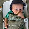 Rhett is registered to the contest to win money with this photo: baby, infant, pacifier, hat, green_clothing, baby_carrier, delight_logo, hand, face, cute, child, seated, soft_cloth, indoor, portrait, looking_at_camera, comfortable, young_child, headwear, baby_equipment