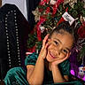 child, girl, smiling, green_dress, christmas_tree, holiday, festive, decorations, ribbons, ornaments, happy, portrait, indoors, celebration, cute, joyful, face, hands, seated, christmas