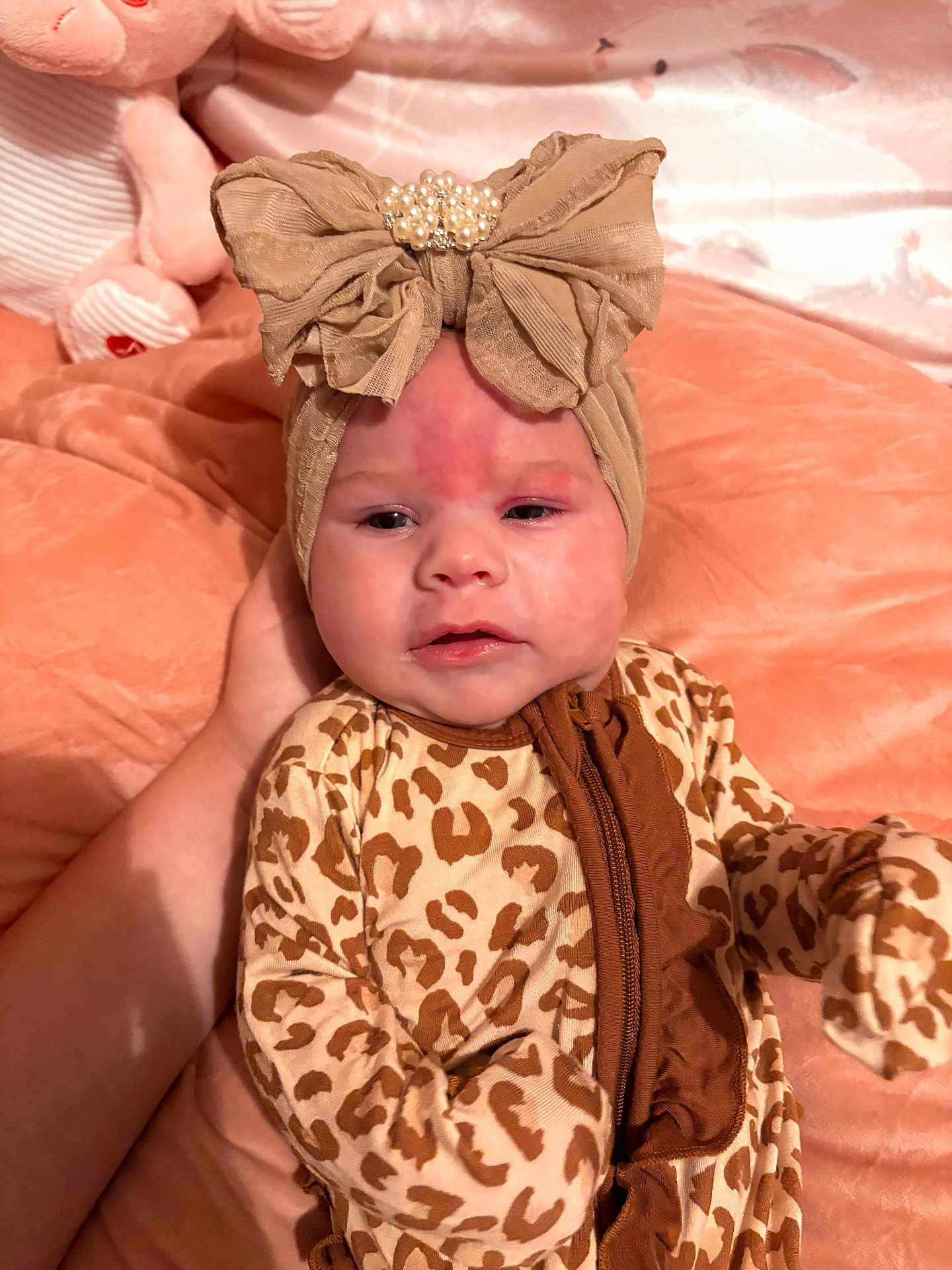 Maxlynn joined the competition — help win amazing prizes! baby, infant, child, headband, bow, leopard_print, onesie, animal_print, hand, plush_toy, blanket, soft_texture, face, person, sleepwear, cute, indoors, resting, skin, expression
