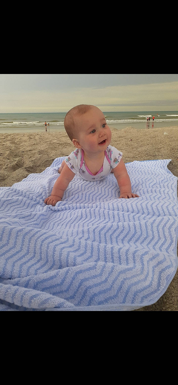 Desiree is registered to the contest to win money with this photo: baby, beach, child, fun, leisure, linens, ocean, person, sand, sea, smile, summer, toddler, vacation