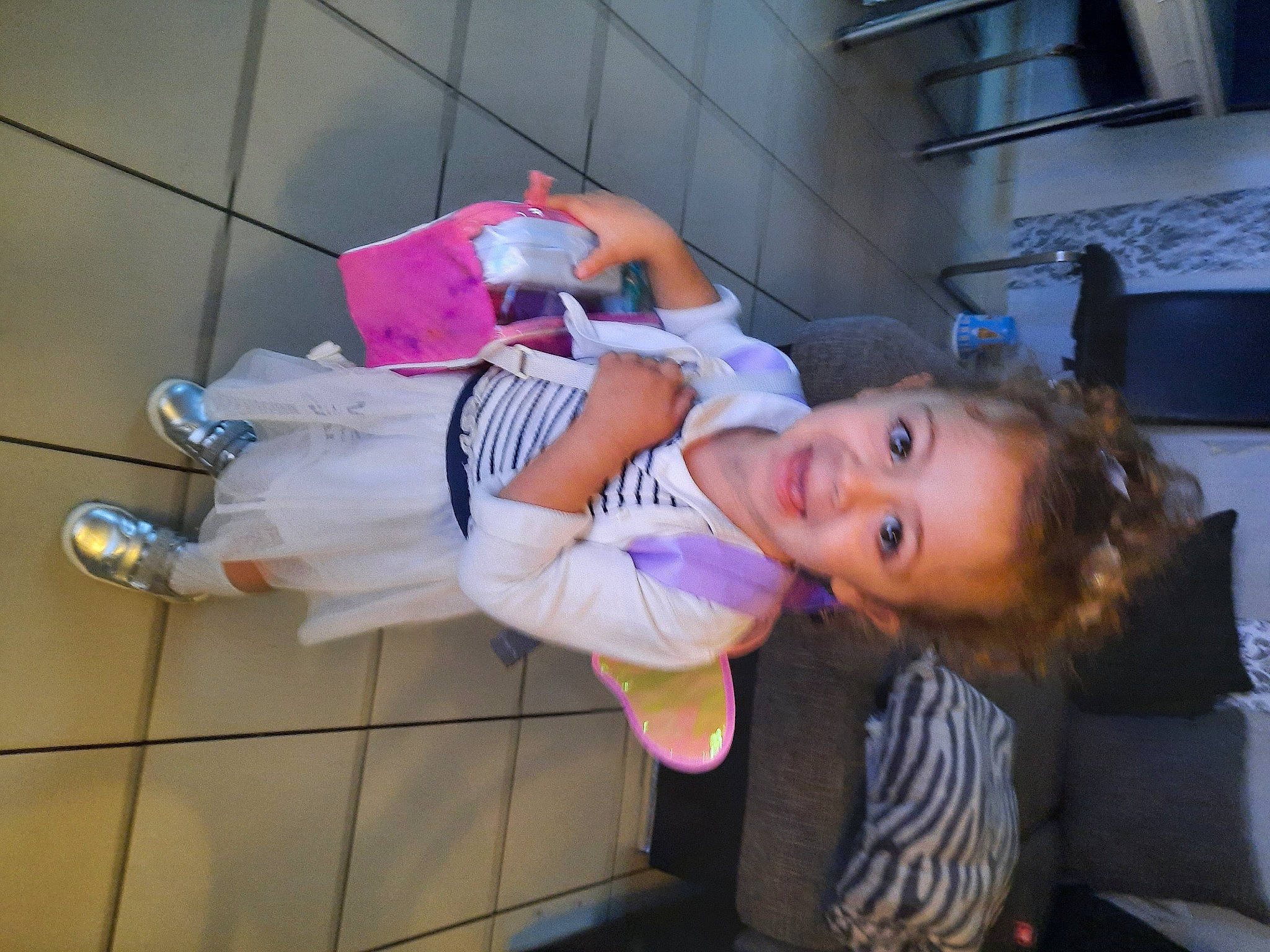 Estelle participe au concours pour gagner de l'argent avec cette photo : child, costume, event, flooring, fun, hat, human_leg, joy, leisure, person, purple, room, smile, thigh, toddler, vacation