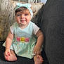 baby, child, headband, bow, couch, cushion, smile, blue_eyes, short_sleeve, dress, feet, toes, sitting, indoor, furniture, happy, cute, infant, portrait, soft_lighting