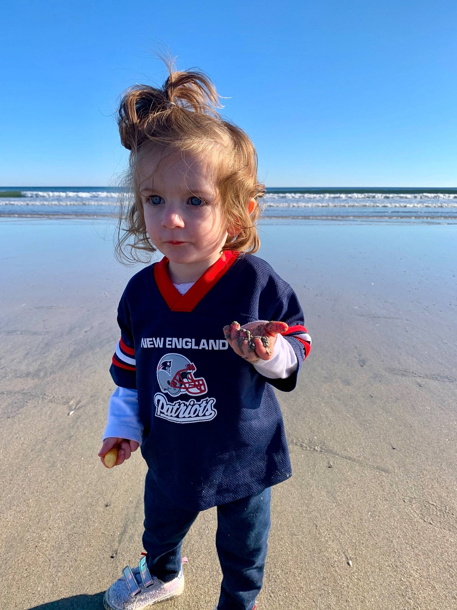 Ellianna is registered to the contest to win money with this photo: baby_toddler_clothing, beach, blond, child, coast, coastal_and_oceanic_landforms, mudflat, ocean, person, reflection, sand, shoal, shoe, shore, sneakers, summer, sweatpant, toddler, toy, walking_shoe