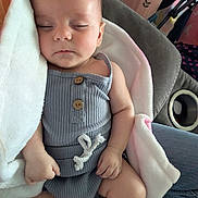 Aria joined the competition — help win amazing prizes! baby, sleeping, blanket, clothing, infant, person, hand, lap, fabric, cute, peaceful, indoor, cozy, soft, skin, wooden_button, seat, jeans, comfort, rest