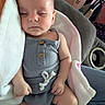 baby, sleeping, blanket, clothing, infant, person, hand, lap, fabric, cute, peaceful, indoor, cozy, soft, skin, wooden_button, seat, jeans, comfort, rest