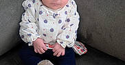 Aria joined the competition — help win amazing prizes! baby, boots, child, couch, cozy, curious_expression, cute, flower, fur_boots, gray_couch, hands, headband, indoors, infant, navy_pants, patterned_clothing, portrait, seated, soft_lighting, white_clothing