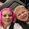 woman, child, selfie, pink_hair, smile, happy, seat, ride, amusement_park, straps, casual_clothing, hoodie, boy, portrait, fun, indoor, neon_lights, entertainment, face, people