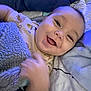Carson joined the competition — help win amazing prizes! baby, smiling, blanket, bed, infant, face, hand, happy, cozy, sleepwear, pillow, cute, child, soft, relaxed, indoors, comfort, portrait, young, expression
