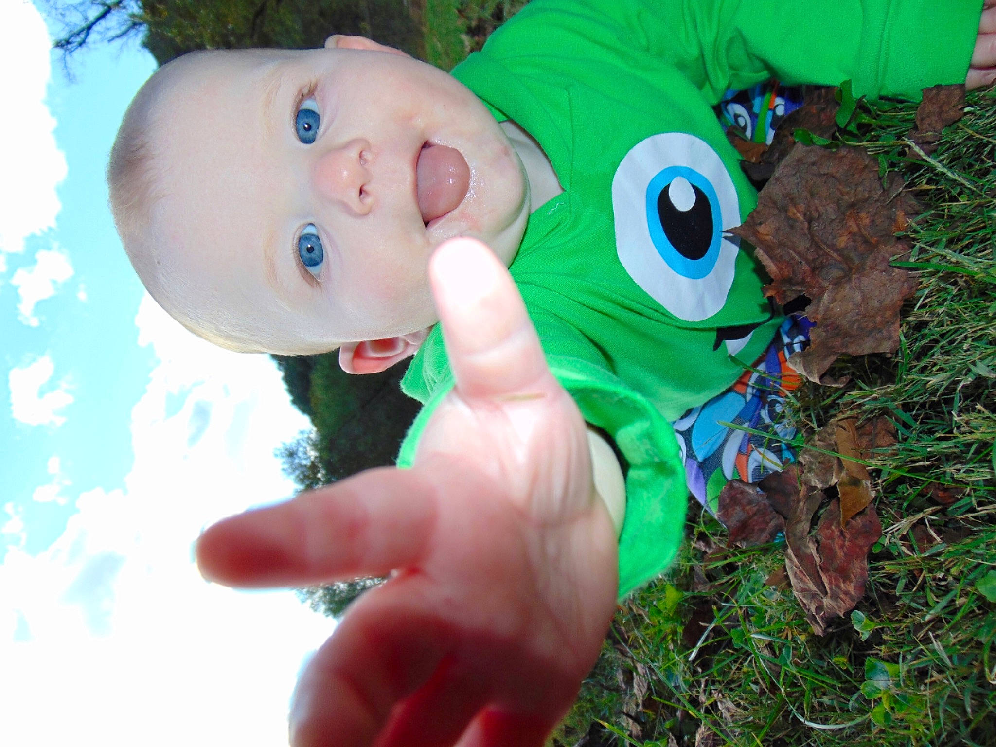 Hendrix is registered to the contest to win money with this photo: baby, baby_toddler_clothing, child, eye, eyelash, fictional_character, fun, gesture, grass, happy, nail, nose, people_in_nature, person, plant, terrestrial_plant, thumb, toddler, toy, tree