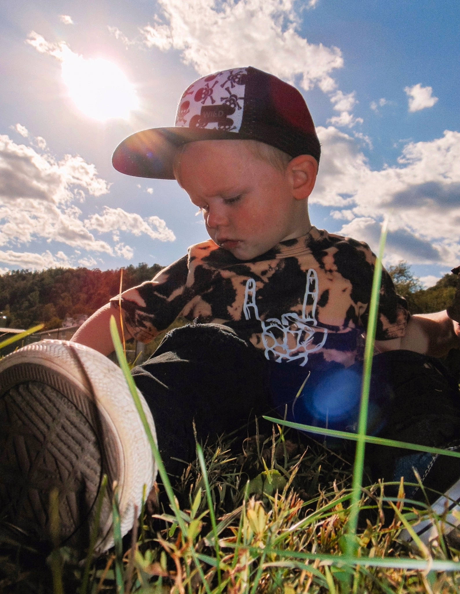 Weston is registered to the contest to win money with this photo: baseball_cap, cap, cloud, flash_photography, fun, grass, grass_family, grassland, happy, landscape, meadow, people_in_nature, person, plant, prairie, shirt, sky, summer, sunlight, t_shirt
